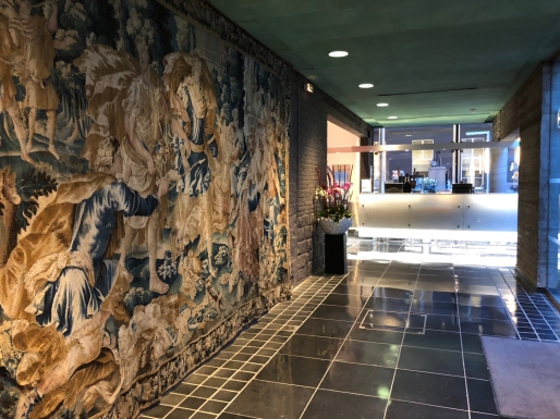 A centuries old tapestry and a futuristic reception desk